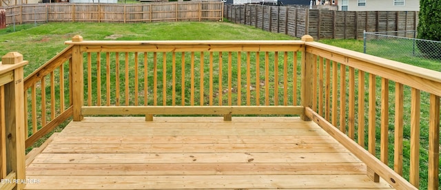 deck with a fenced backyard and a yard