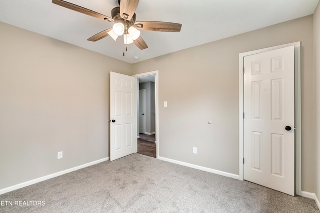 unfurnished bedroom featuring baseboards, a ceiling fan, and carpet