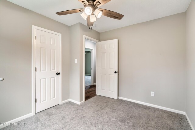 unfurnished bedroom featuring carpet flooring, baseboards, and ceiling fan