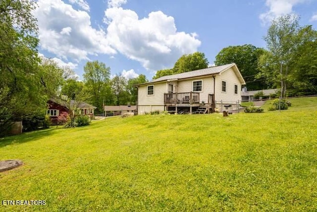 back of house featuring a yard and a deck
