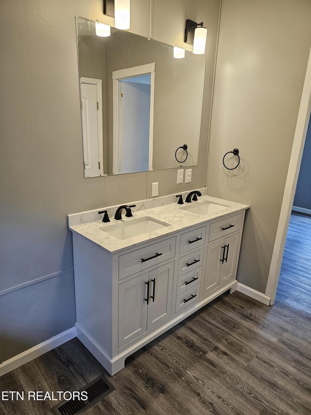 367 Mcjunkin Rd, Tellico Plains, TN 37385 - bathroom with double vanity, a sink, and wood finished floors