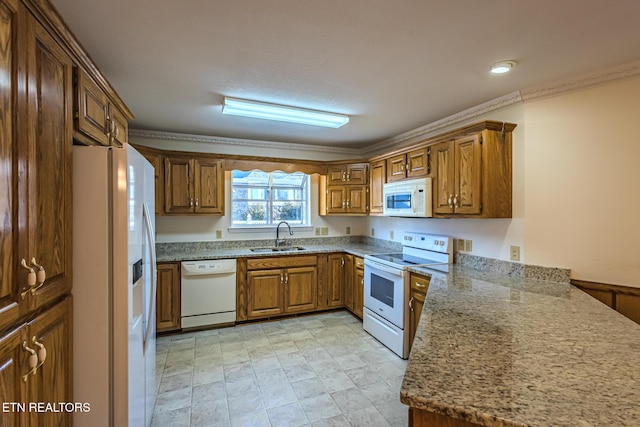 kitchen featuring light stone counters, a sink, brown cabinetry, white appliances, and ornamental molding