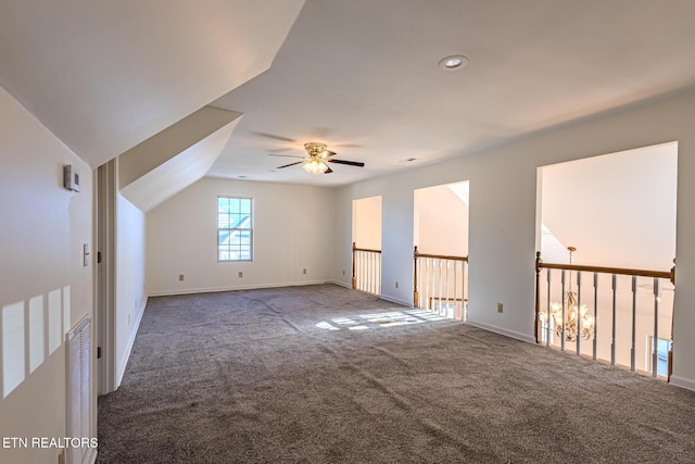 unfurnished room with baseboards, lofted ceiling, carpet flooring, and a ceiling fan