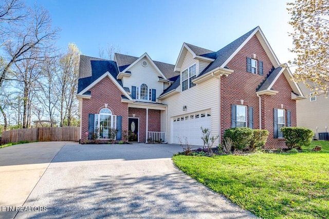 traditional-style home featuring central air condition unit, fence, driveway, a front lawn, and brick siding
