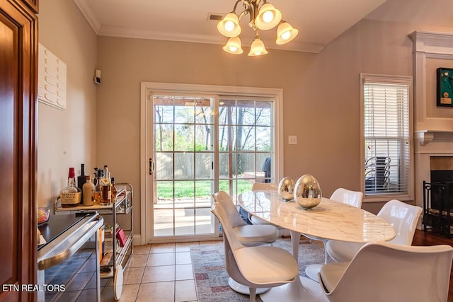 dining room with ornamental molding, light tile patterned floors, a notable chandelier, and visible vents