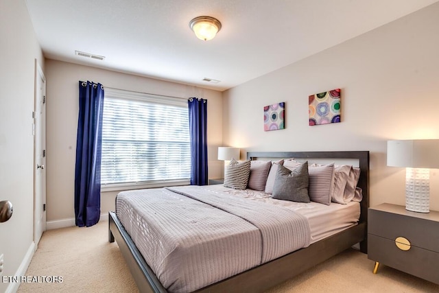 bedroom with light carpet, baseboards, and visible vents