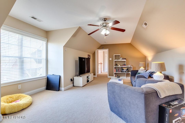 carpeted living room with vaulted ceiling, visible vents, baseboards, and a ceiling fan