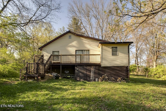 rear view of house featuring stairway, a yard, and a wooden deck
