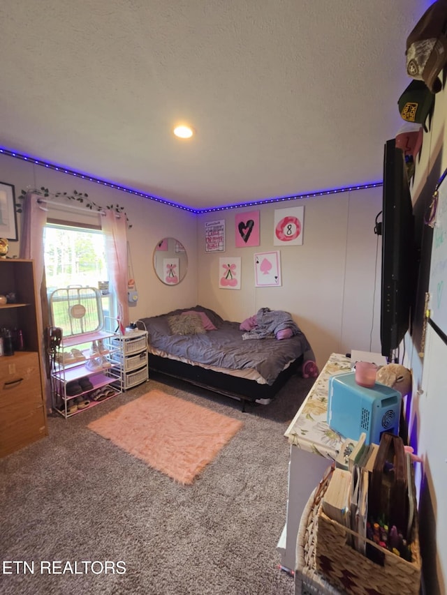 bedroom with a textured ceiling and carpet floors