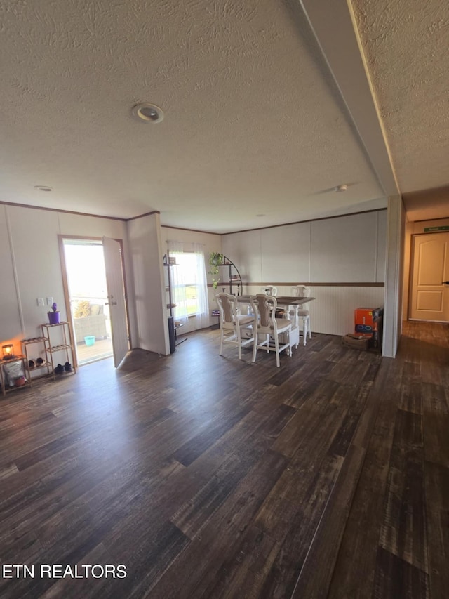 dining room featuring a textured ceiling and wood finished floors