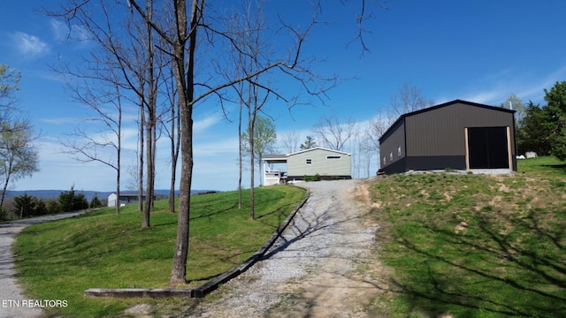 exterior space with an outbuilding and driveway
