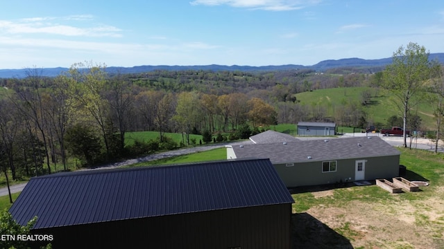 drone / aerial view with a forest view and a mountain view