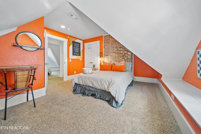 carpeted bedroom with baseboards, visible vents, and vaulted ceiling