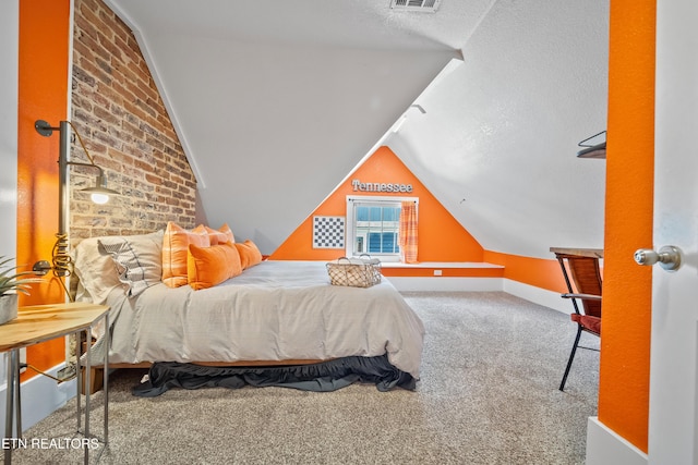 carpeted bedroom with visible vents, vaulted ceiling, and a textured ceiling