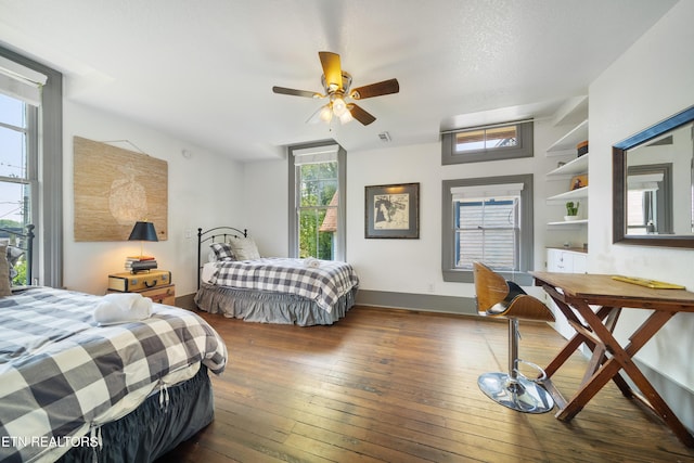 bedroom featuring hardwood / wood-style flooring, baseboards, and visible vents