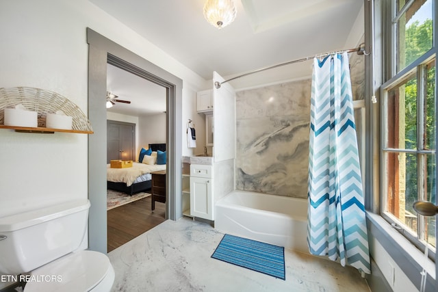 ensuite bathroom with connected bathroom, toilet, and shower / tub combo with curtain
