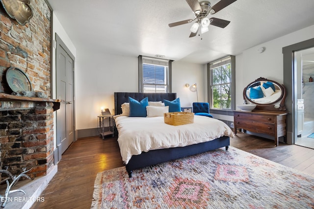 bedroom featuring baseboards, a textured ceiling, a ceiling fan, and wood-type flooring