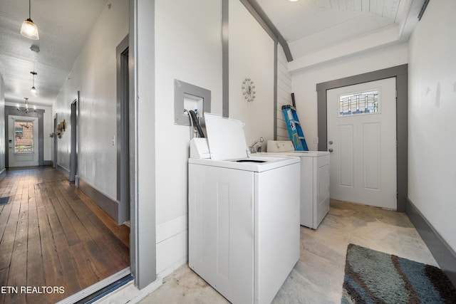 laundry room with baseboards, washing machine and dryer, and light wood finished floors