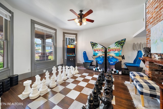 interior space featuring baseboards, wood finished floors, and ceiling fan