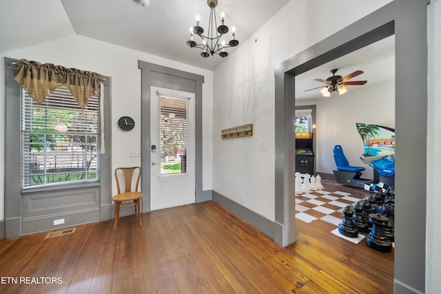 entryway featuring hardwood / wood-style floors, lofted ceiling, visible vents, and a healthy amount of sunlight
