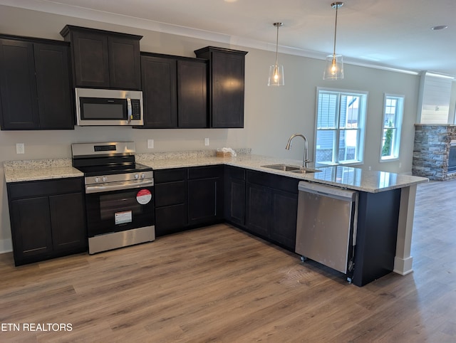 110 Roseberry St Lot 6B, Oak Ridge, TN 37830 - kitchen featuring stainless steel appliances, a peninsula, light wood-type flooring, crown molding, and light stone counters