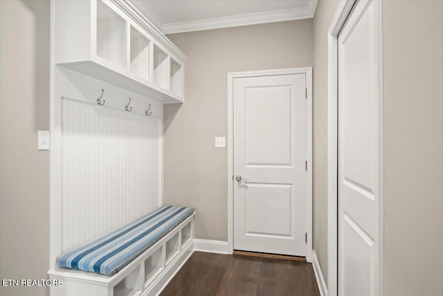 mudroom featuring dark wood-type flooring, ornamental molding, and baseboards