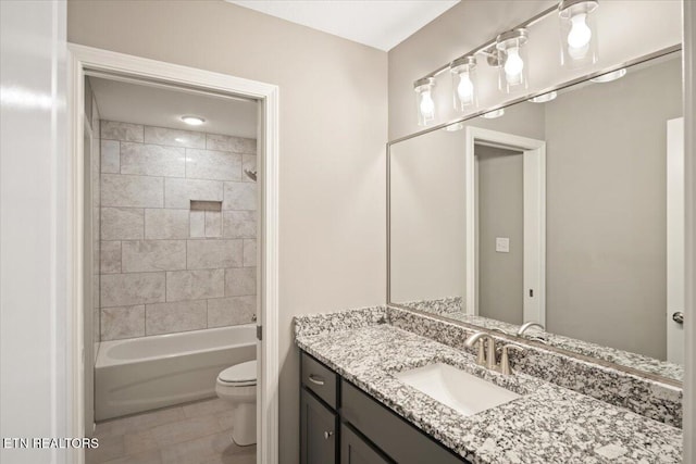 bathroom featuring shower / bathing tub combination, tile patterned floors, toilet, and vanity