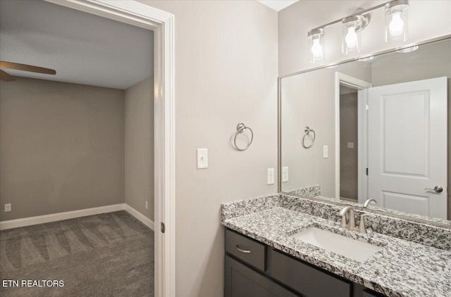 bathroom featuring a ceiling fan, vanity, and baseboards