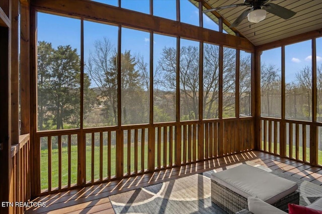 unfurnished sunroom with a ceiling fan