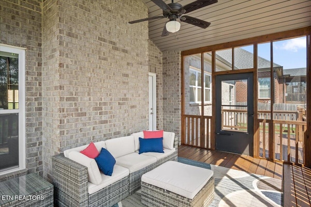 sunroom / solarium with an outdoor living space and a ceiling fan