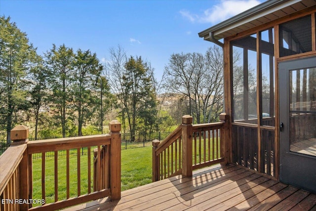 wooden deck with a lawn, a sunroom, and fence