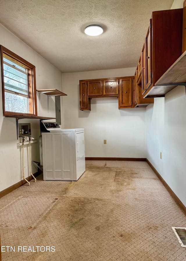 laundry area featuring cabinet space, washer / dryer, baseboards, and visible vents