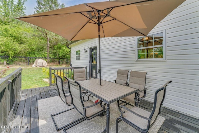 deck featuring a yard, outdoor dining space, and a fenced backyard
