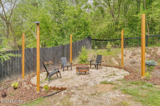 view of patio / terrace with a fire pit and fence private yard