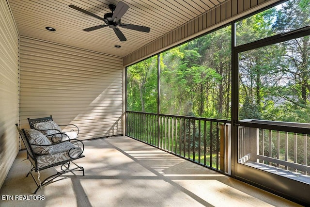 unfurnished sunroom with a ceiling fan