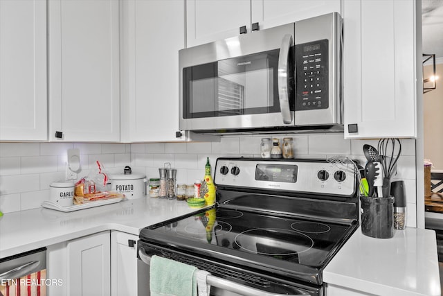 kitchen featuring light countertops, backsplash, white cabinets, and stainless steel appliances