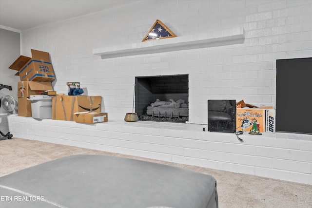 room details with a brick fireplace, carpet, and crown molding