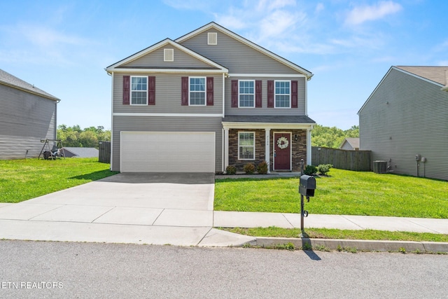 view of front of home with fence, an attached garage, driveway, and a front lawn