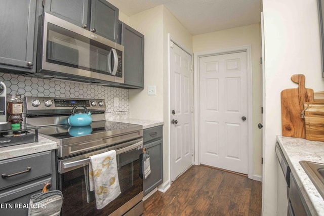 5836 Windtree Ln, Knoxville, TN 37921 - kitchen with baseboards, appliances with stainless steel finishes, dark wood finished floors, gray cabinets, and decorative backsplash