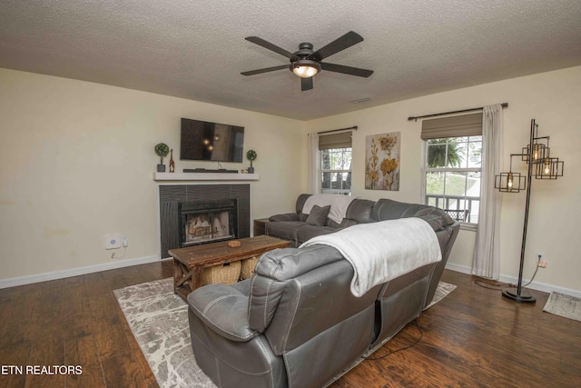 5836 Windtree Ln, Knoxville, TN 37921 - living room featuring baseboards, ceiling fan, a fireplace, a textured ceiling, and wood finished floors