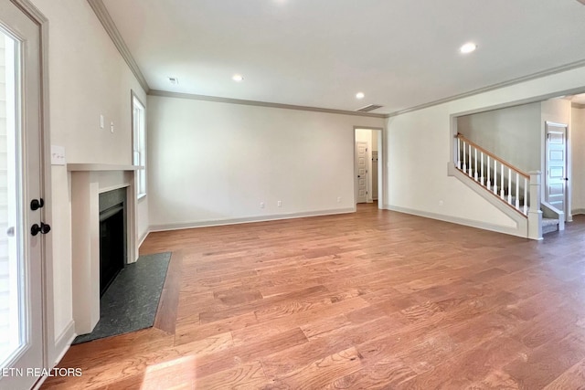 unfurnished living room with stairs, recessed lighting, baseboards, light wood finished floors, and a fireplace