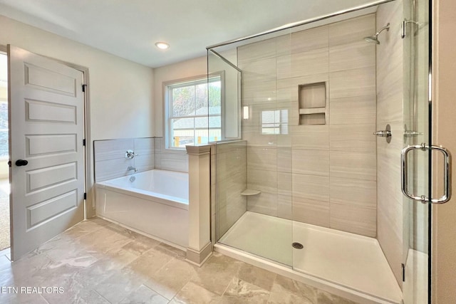full bath featuring a bath and a shower stall