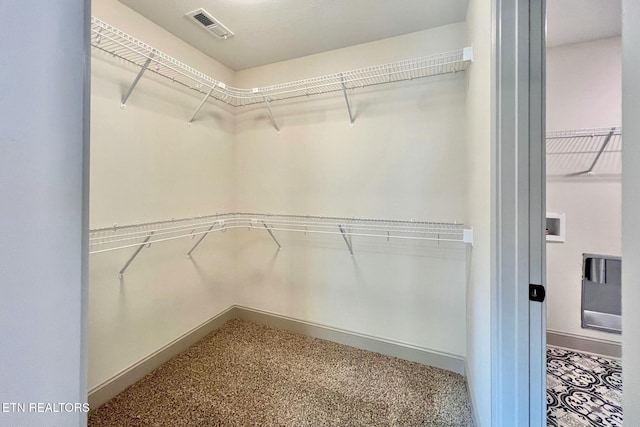 walk in closet with carpet floors and visible vents