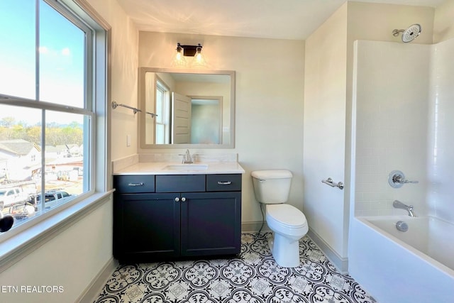 bathroom with tub / shower combination, baseboards, toilet, vanity, and tile patterned flooring