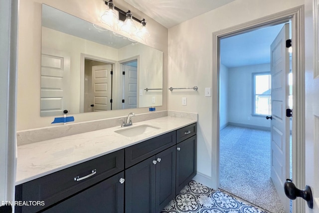 bathroom featuring baseboards and vanity