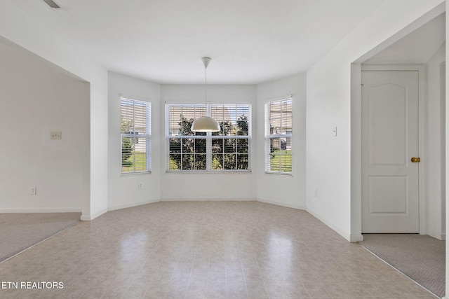unfurnished dining area featuring baseboards