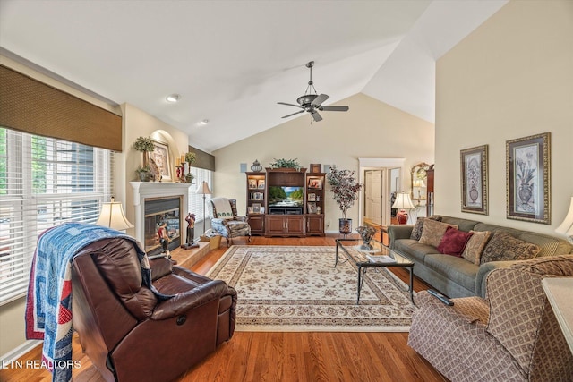 106 Mariners Dr, Fairfield Glade, TN 38558 - living area with a ceiling fan, a glass covered fireplace, wood finished floors, and vaulted ceiling