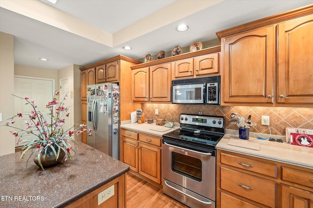 106 Mariners Dr, Fairfield Glade, TN 38558 - kitchen with recessed lighting, light wood finished floors, tasteful backsplash, and stainless steel appliances