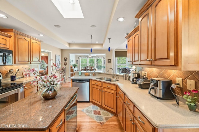 106 Mariners Dr, Fairfield Glade, TN 38558 - kitchen featuring brown cabinets, stainless steel appliances, a sink, and light wood-type flooring