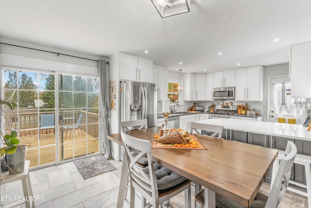 dining space featuring recessed lighting